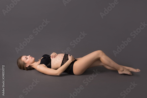 pregnant girl. pregnant on a dark background. pregnant in lingerie.