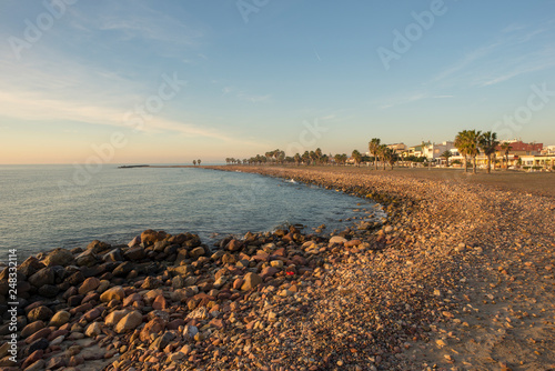 The coast and beach of chilches at sunrise photo