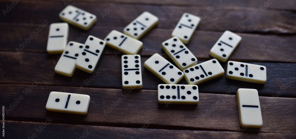 white dominoes on a wooden table white dominoes on a wooden table
