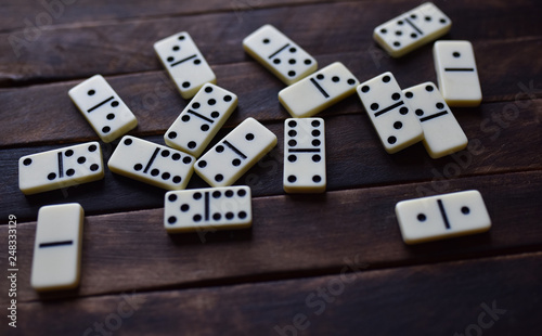white dominoes on a wooden table