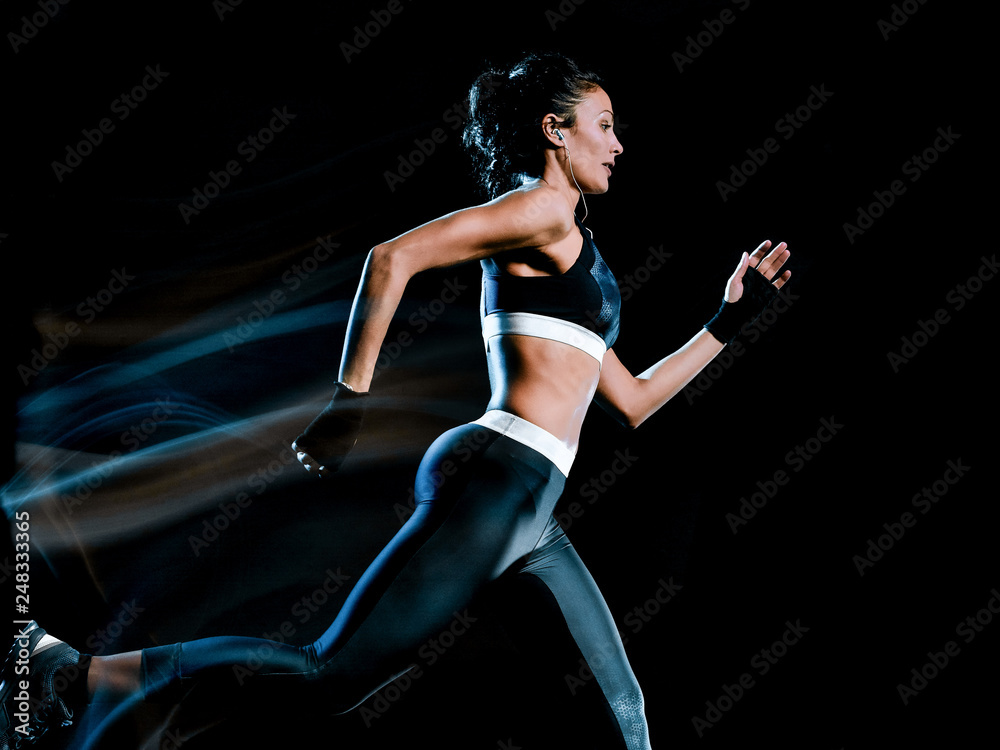 one beautiful caucasian mixed race woman unner jogger jogging running  in studio isolated on black background