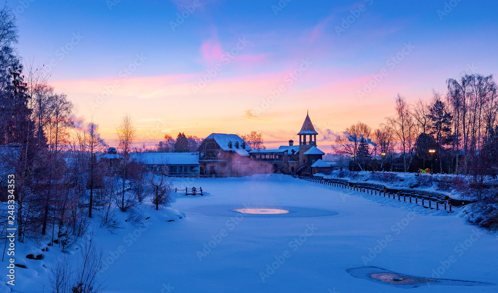 Fototapeta premium Winter sunrise over a snow-covered lake