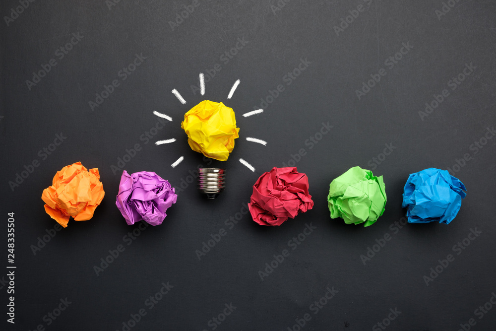 Great idea concept with crumpled colorful paper and light bulb on black background - obrazy, fototapety, plakaty 