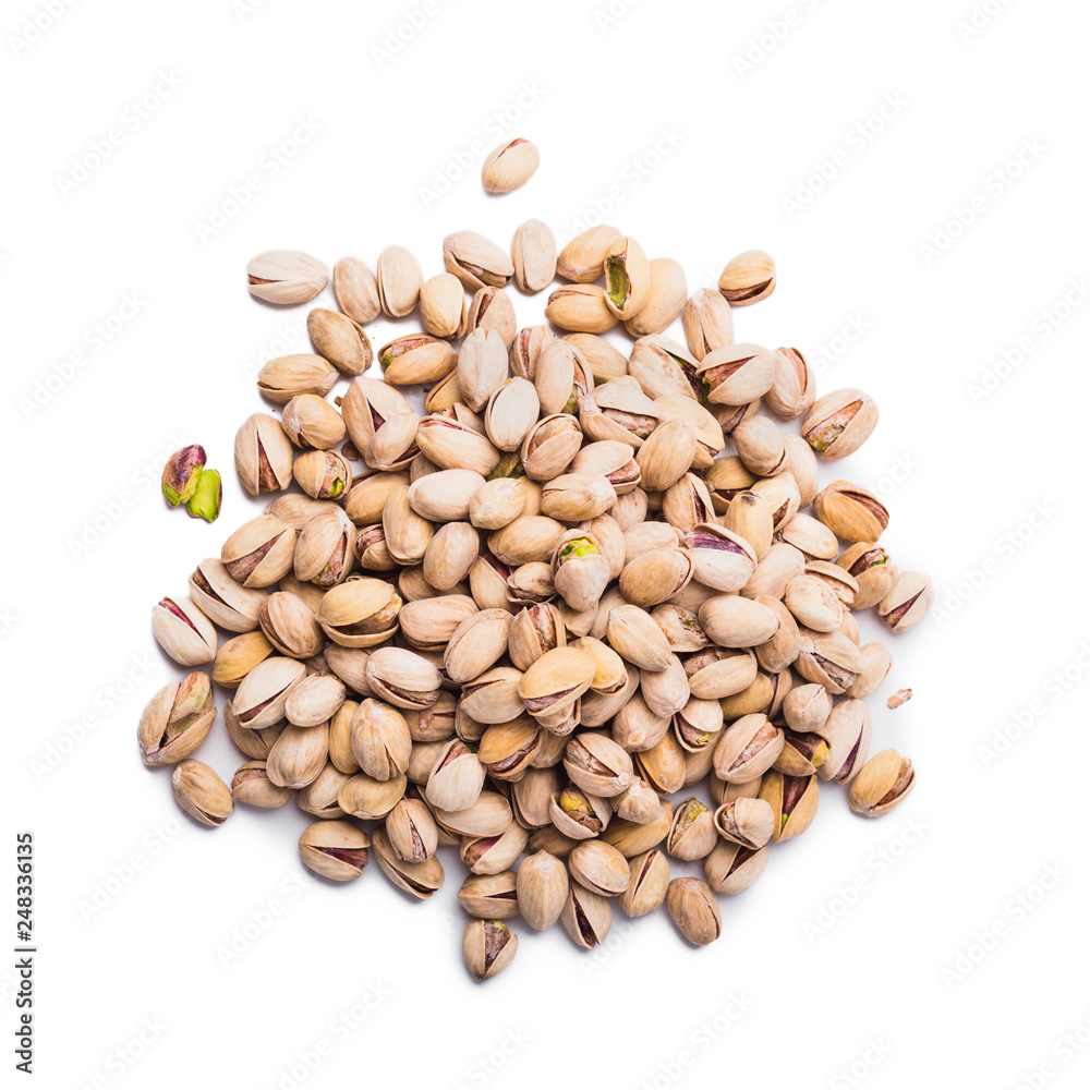 Heap of pistachio nuts isolated over white background, top view