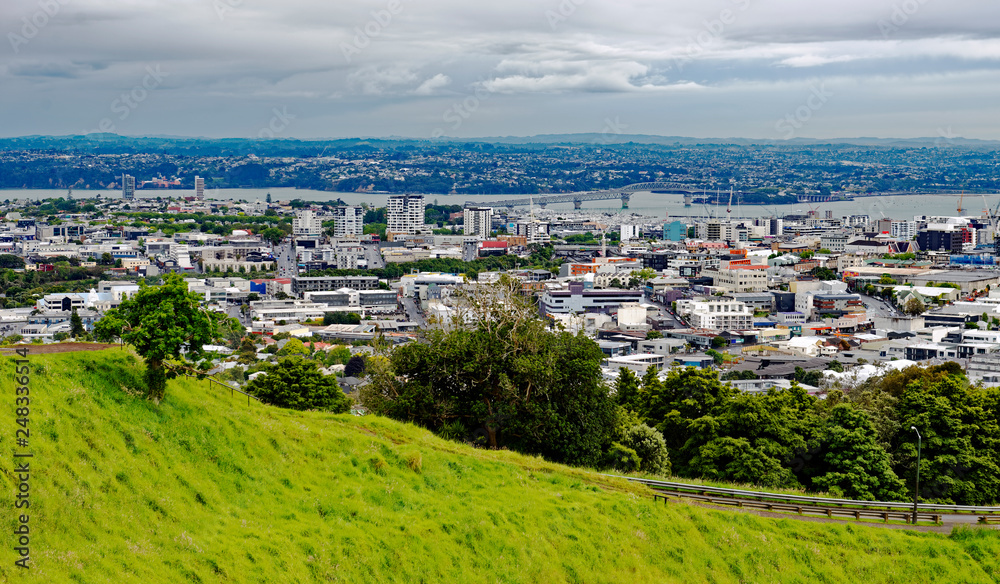 Overlook from Mt. Eden of the Auckland, New Zealand harbour bridge and the outer business district