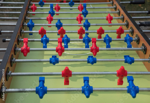 Table football in the entertainment center. Close-up image of plastic players in a football game