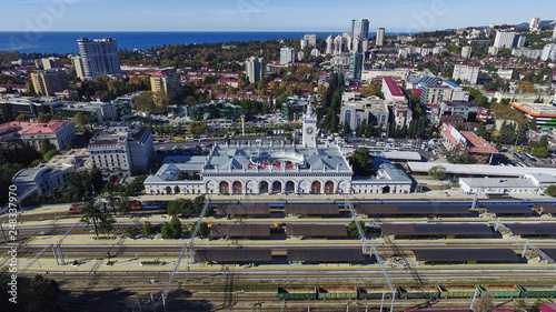 Sochi railway station building is in of city. Aerial view from platform. Sochi is city in Krasnodarskiy kray and Black Sea and summer beach resort photo