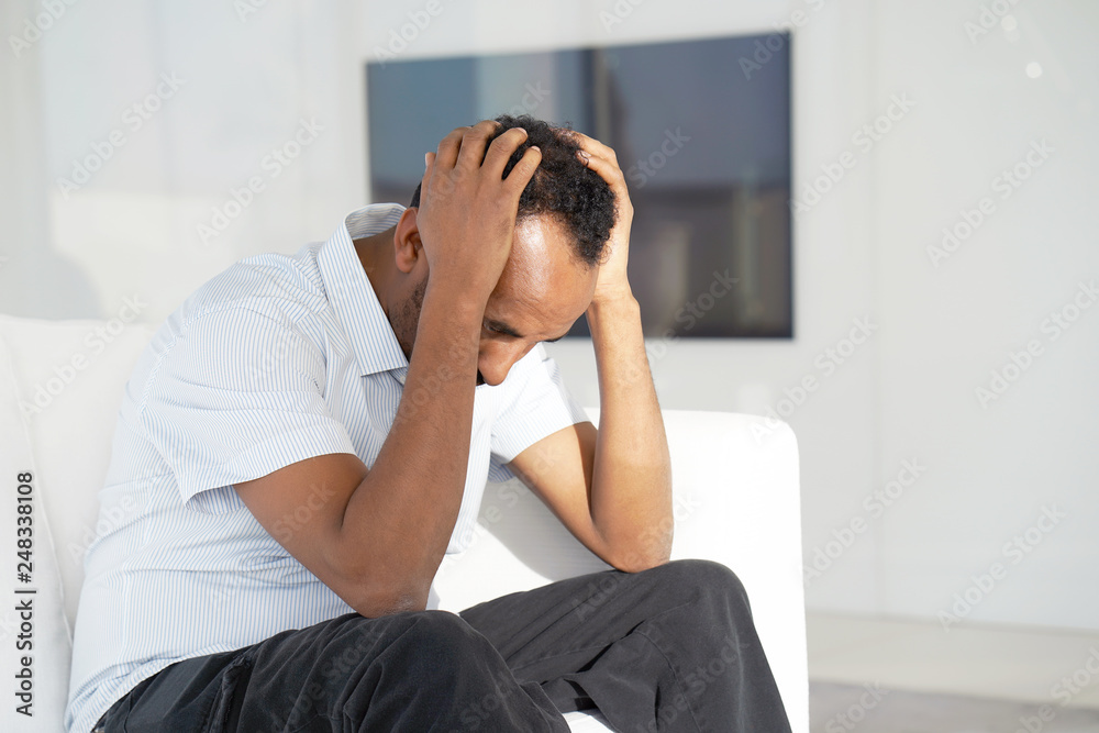 Loss of a loved one. Grief in the family. Death of a child. Sad face depressed african man. Very sad man. Concept of loneliness and pain. Loss of a loved one. Grief in the family. Death of a child. Sad face depressed african man. Very sad man. Concept of loneliness and pain.