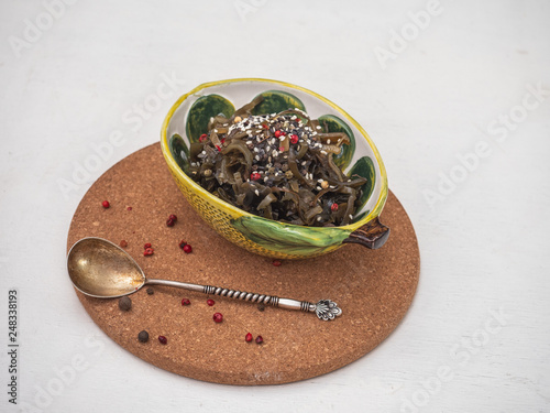 Marinated seaweed in a decorative ceramic salad bowl photo