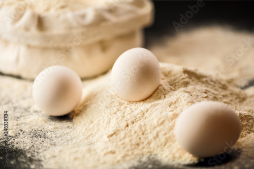 White eggs on a pile of flour.