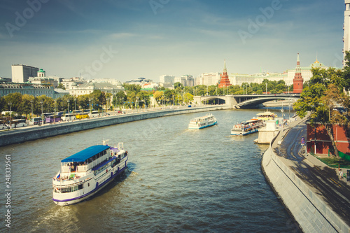 Bridge view to Moscow river tourist boats and Kremlin towers, Moscow, Russia