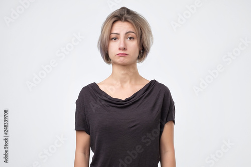 Fotografie Sad woman serious and concerned looking worried and thoughtful at camera