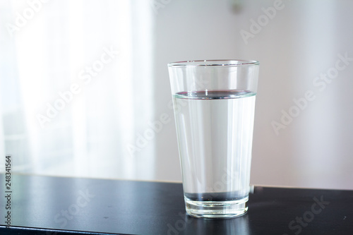 Glass of water on the table background
