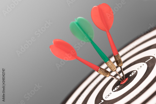 Dartboard with dart in center. Concept of target in business and success