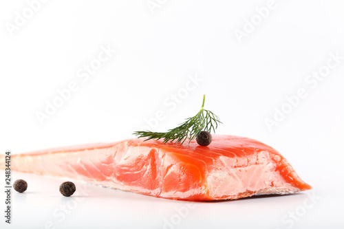 salmon on a white background with herbs and spices