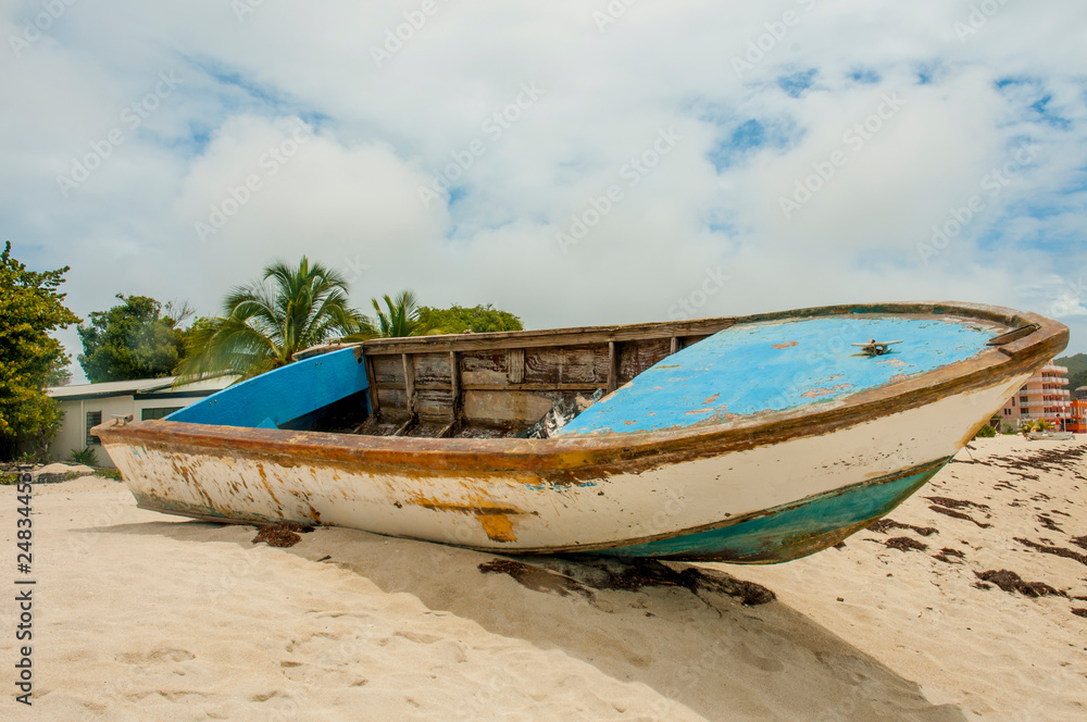 Old wooden boat atop sandy beach bluff Old wooden boat atop sandy beach bluff
