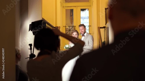 backstage wedding photography - professional photographers take pictures of newlyweds in a chic room
