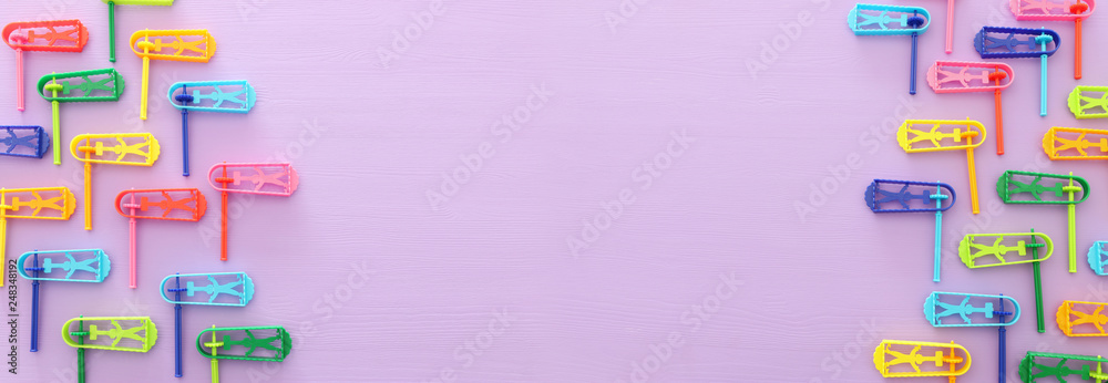 top view image of Purim celebration concept (jewish carnival holiday) over purple background. Top view, flat lay. top view image of Purim celebration concept (jewish carnival holiday) over purple background. Top view, flat lay.