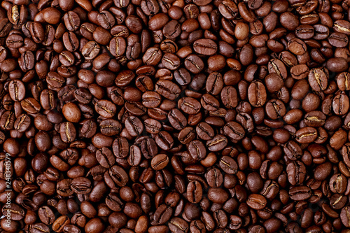 Aroma roasted coffee beans, brown banner background. Soft focus close up.