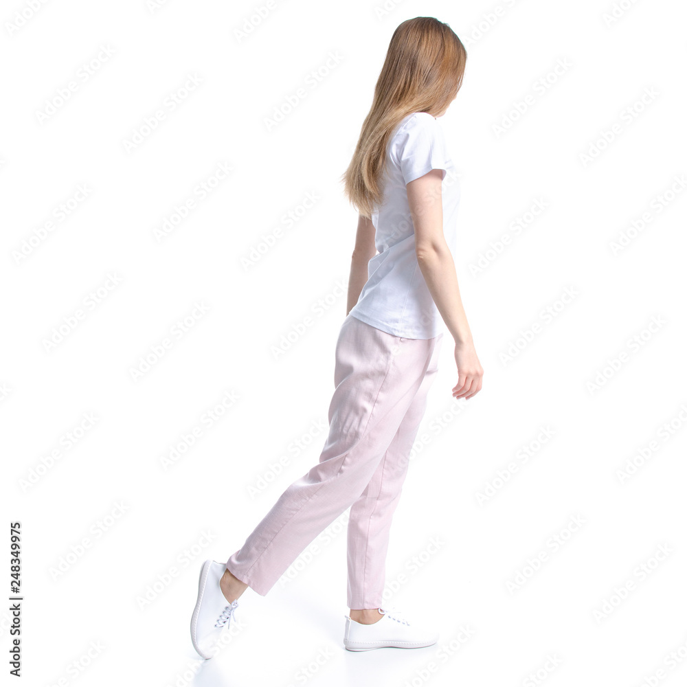 Woman in white t-shirt walking goes on white background isolation, back view Woman in white t-shirt walking goes on white background isolation, back view