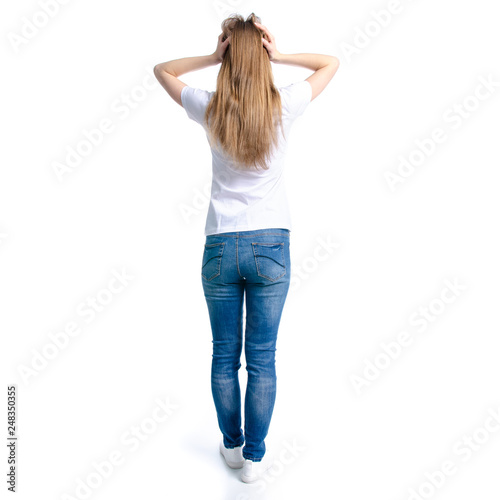 Woman in jeans and white t-shirt holding head on white background isolation, back view