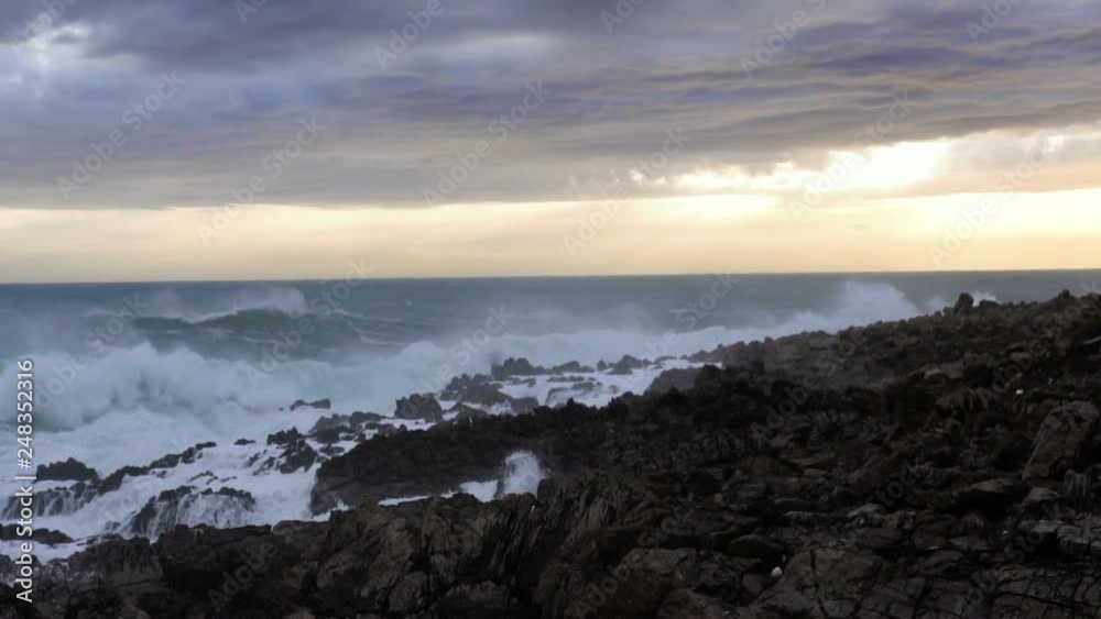 Huge waves break on the stones, slow motion Huge waves break on the stones, slow motion