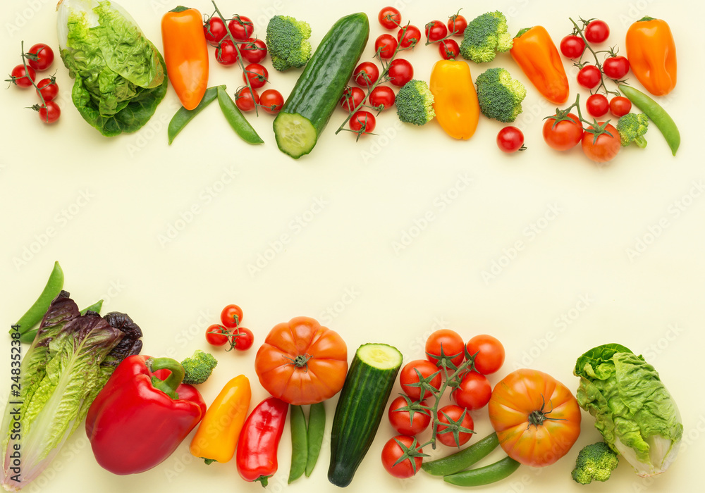 Raw vegetables background, tomatoes cucumbers lettuce pepper spring onion broccoli peas on light yellow table, top view, copy space, selective focus Raw vegetables background, tomatoes cucumbers lettuce pepper spring onion broccoli peas on light yellow table, top view, copy space, selective focus