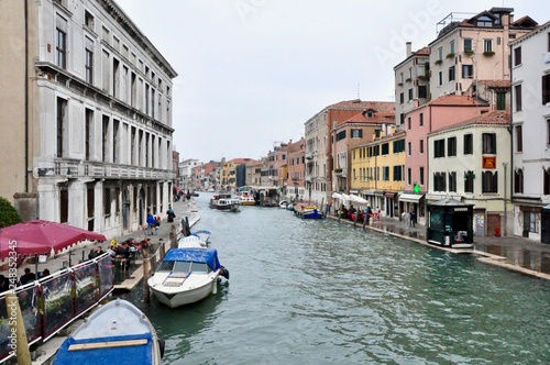 Classic Venice channel view with typical buildings  colorful windows  bridges and boats