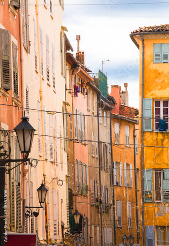 Fototapeta Naklejka Na Ścianę i Meble -  Bright facades on streets of Grass, small French village