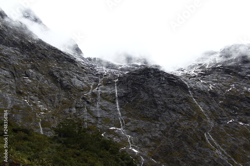 Unlimited rain waterfalls in Fjordland, Milford Road, Milford Sound, New Zealand, South Island photo