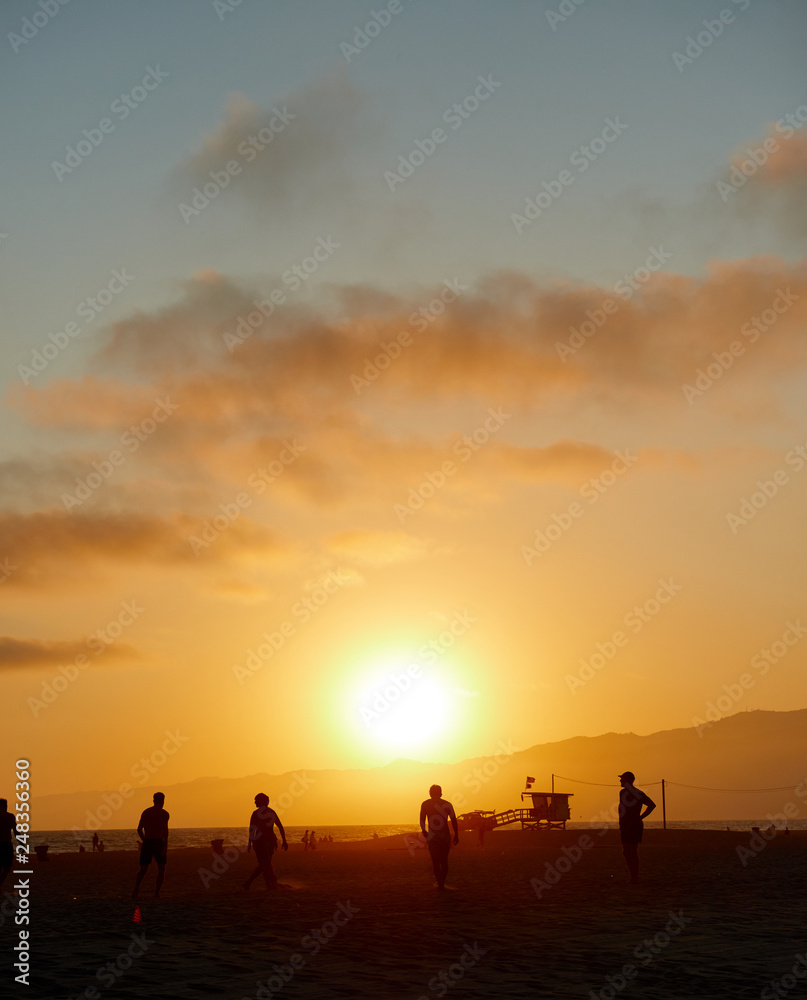 People on Los Angeles Santa Monica beach during sunset