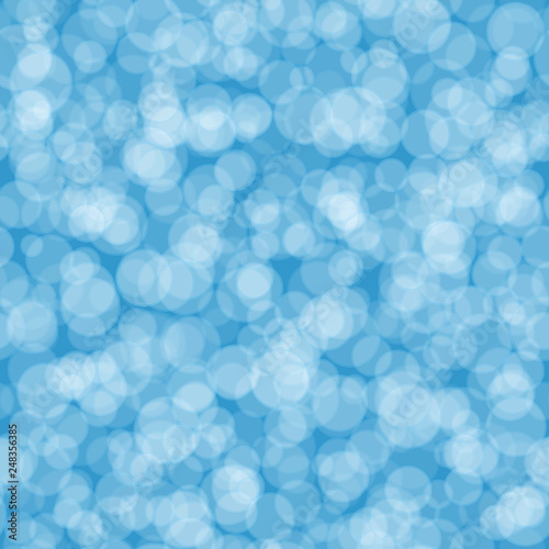 Abstract seamless pattern of randomly distributed translucent circles in light blue colors