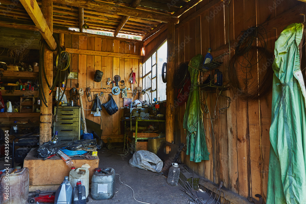 Obraz premium Workshop shed garage with toold for repare and atv inside