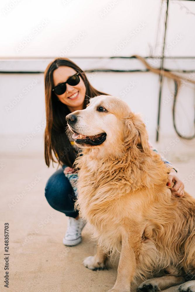 Beauty woman with her dog playing outdoors Beauty woman with her dog playing outdoors