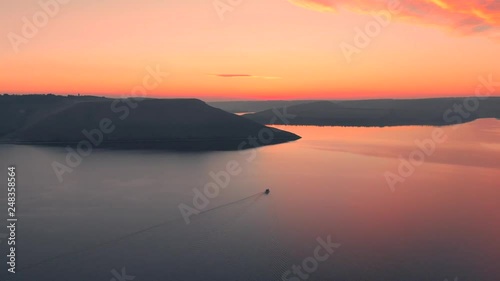 Aerial fly above the water at Bakota Bay, Ukraine, scenic lanscape of sunset - sunrise, 4K