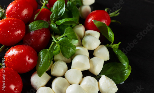 Mozzarella with basil and tomatoes.