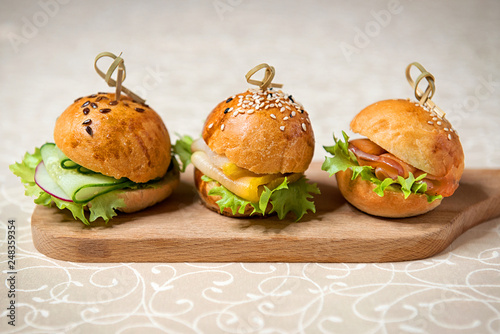 Miniburgers for the buffet on the kitchen board. Restaurant menu.