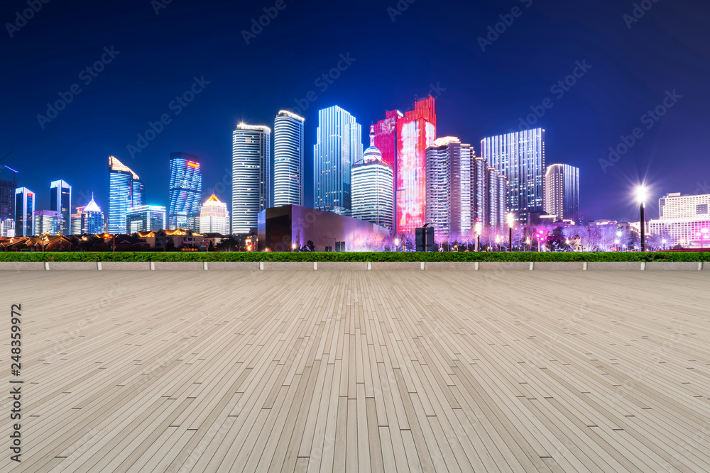 Fototapeta premium Empty Plaza Floor Bricks and the Skyline of Modern Urban Architecture in Qingdao..