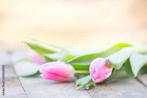 Fototapeta Naklejka Na Ścianę i Meble -  Pink tulips on rustic wooden table romantic background