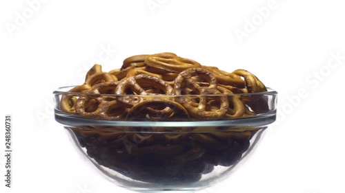 Pretzel salted in rotation. Close up. Studio shot. isolated on white. Unhealthy diet concept. Junk food concept.