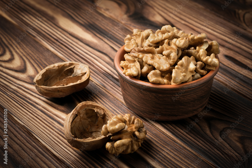Lots of walnut kernels in ceramic dishes and cracked walnut nearby Lots of walnut kernels in ceramic dishes and cracked walnut nearby