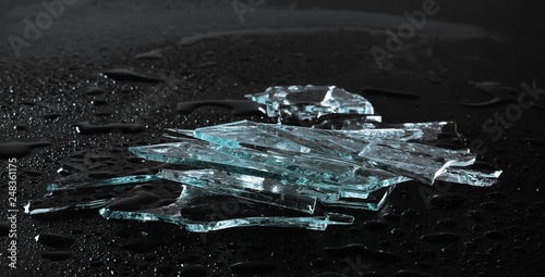 Broken glass pile pieces with water droplets isolated on black background and texture © dule964