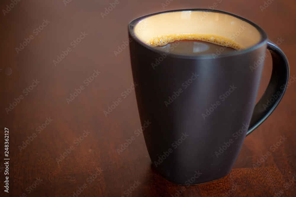 Black coffee cup on wooden table Black coffee cup on wooden table