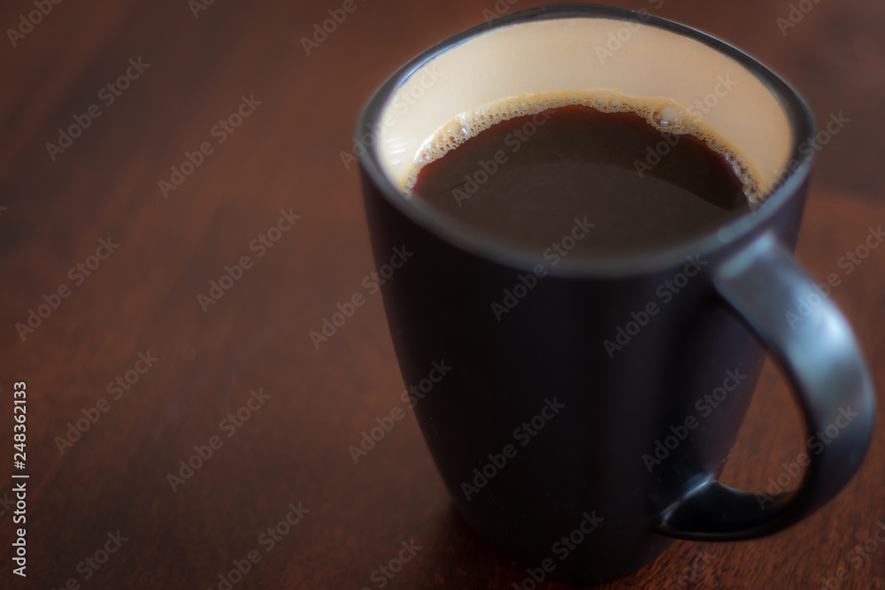 Black coffee cup on wooden table Black coffee cup on wooden table