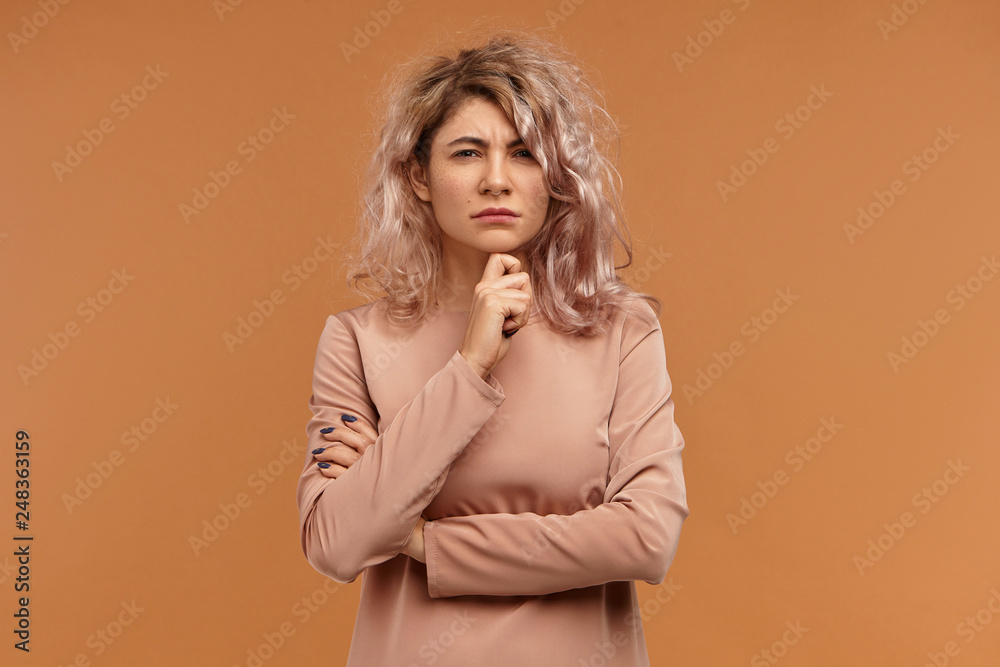 Distrust and suspicion concept. Isolated shot of stylish hipster girl touching chin and staring at camera. Frowning serious young woman having pensive deep in thoughts look, thinking about problems Distrust and suspicion concept. Isolated shot of stylish hipster girl touching chin and staring at camera. Frowning serious young woman having pensive deep in thoughts look, thinking about problems
