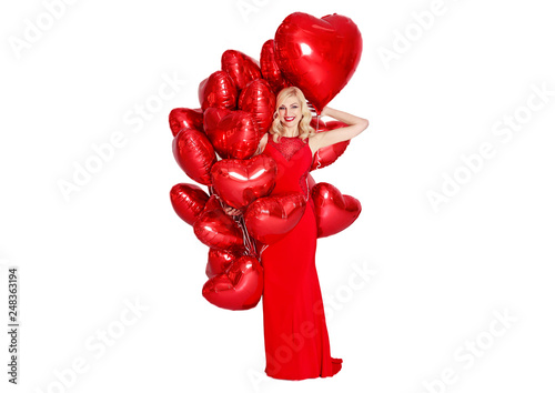 Beautiful smiling blond woman posing and holding red balloons heart. Valentine's day. isolated on white