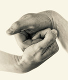 Male and female hands connect with each other. Black and white image.