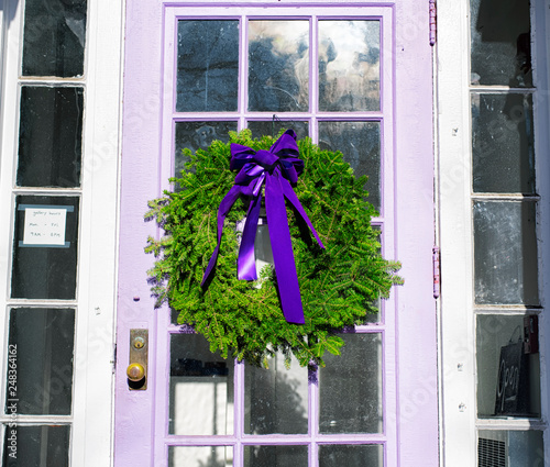 A christmas wreath hanging on a door photo