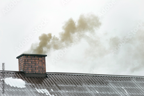 Smoke coming out of the house chimney