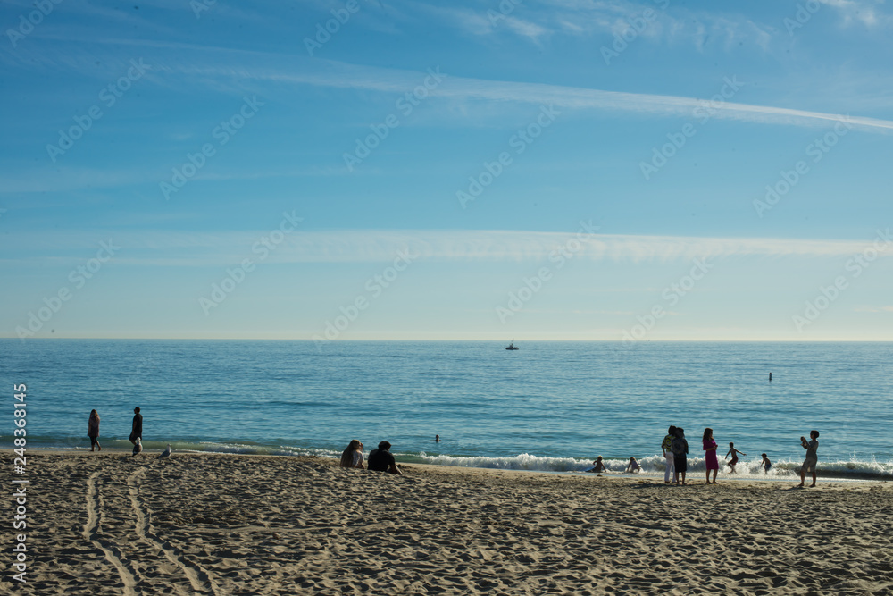 people on beach with blue sky